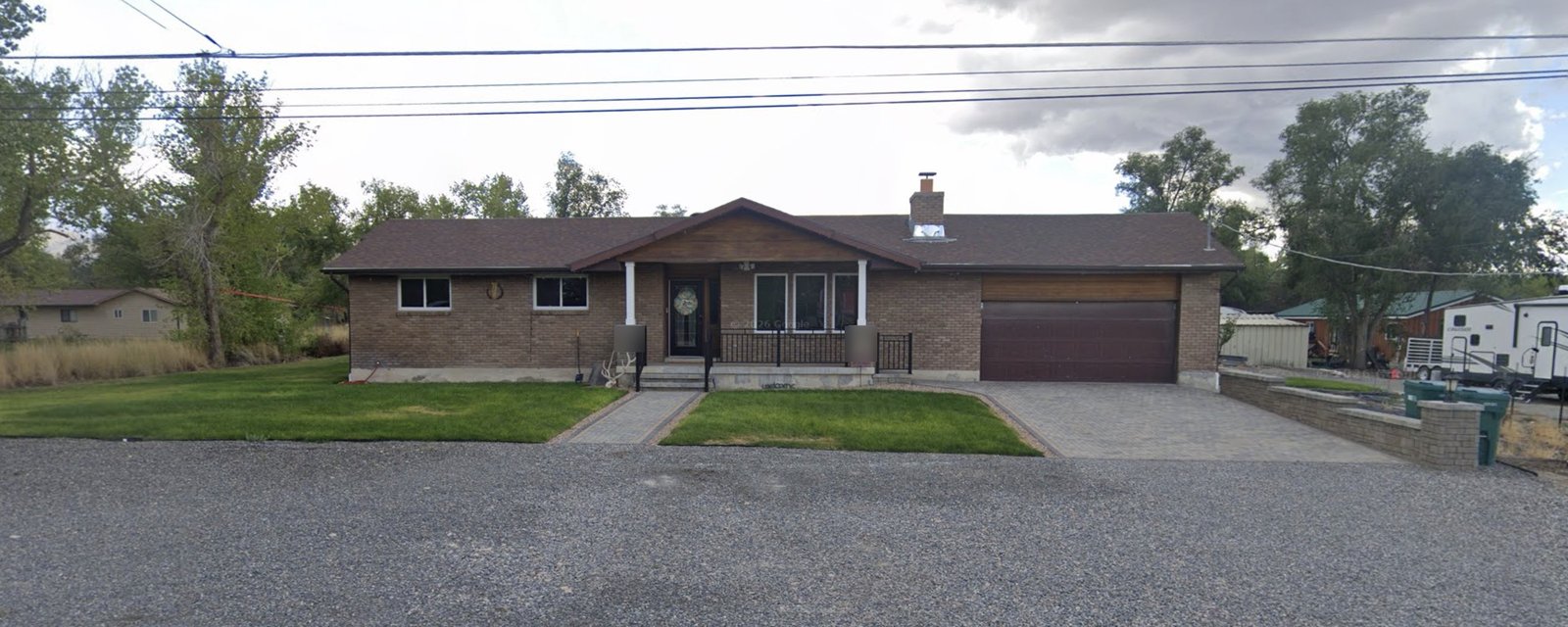 After: front of the house with a paver driveway, paver walkway and new lawn
