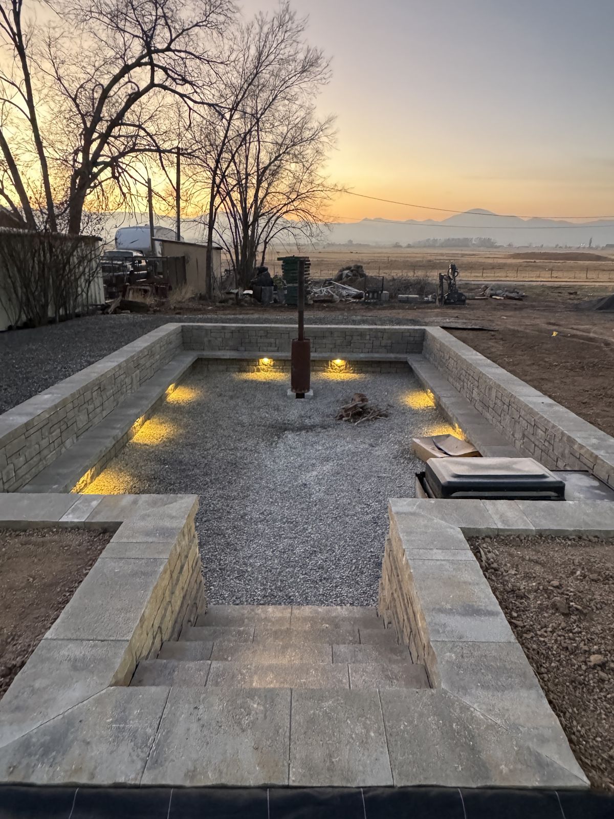 Lit sunken paver patio at sunset in Utah County