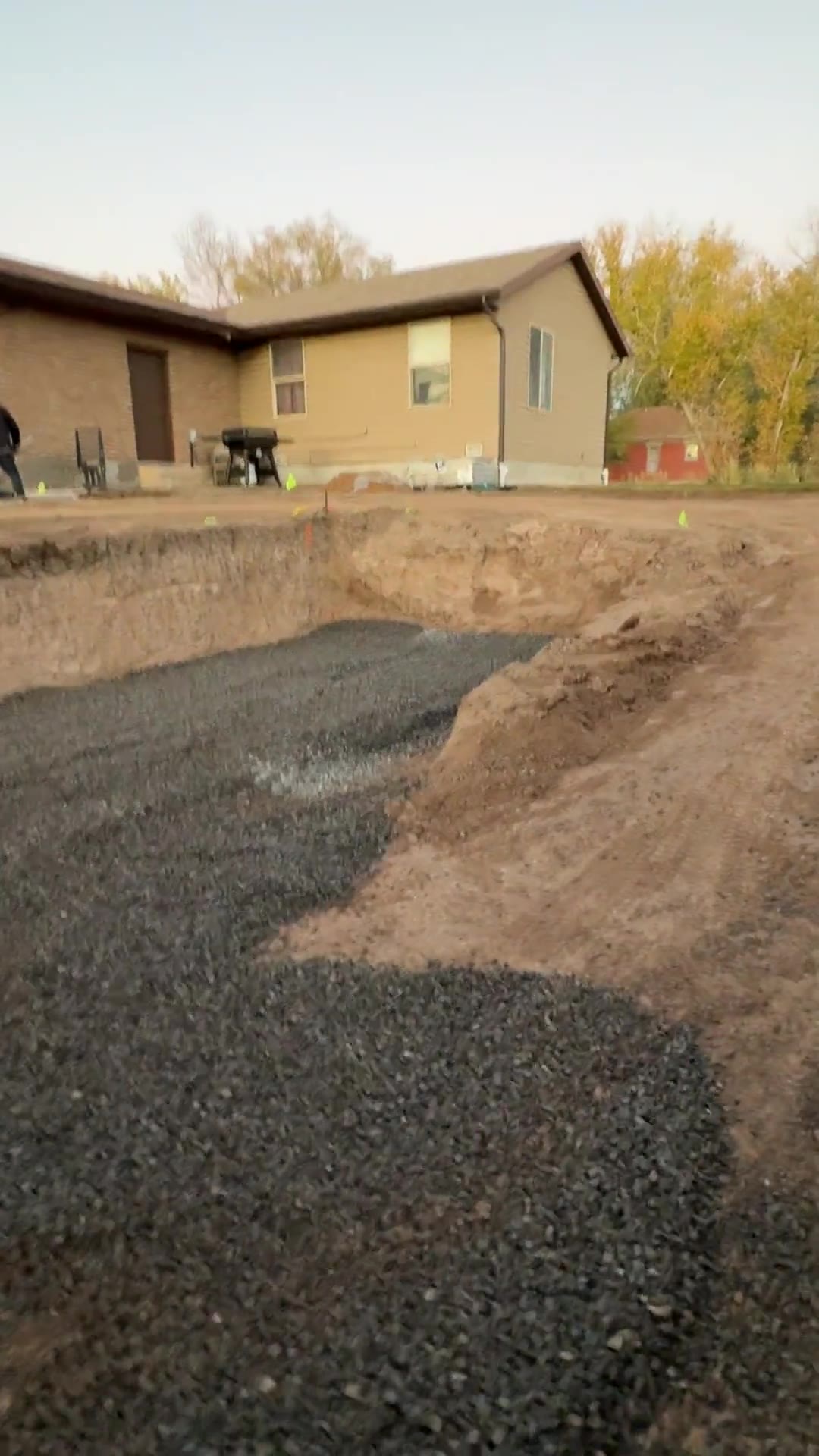 Excavated sunken patio area with a compacted gravel base