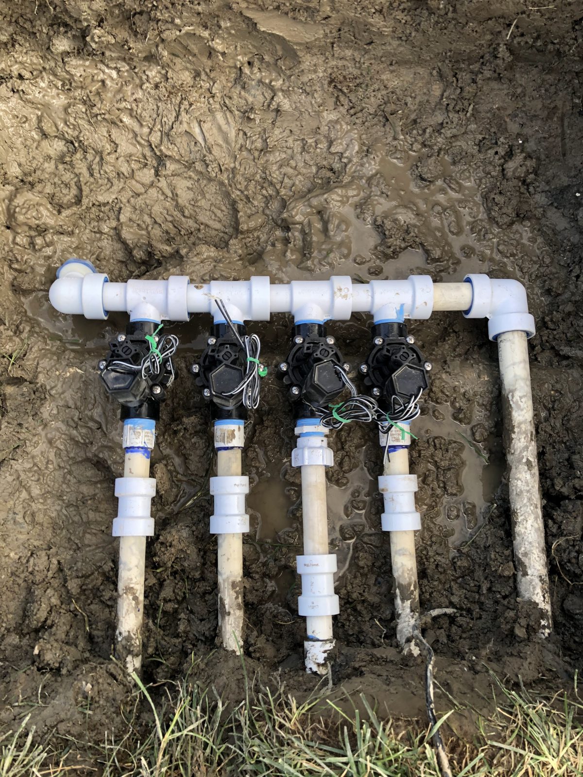 Four-valve PVC sprinkler manifold assembled for a new install