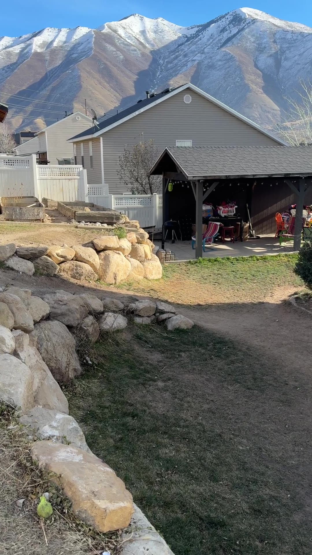 Before: dirt path along a boulder border with mountain view