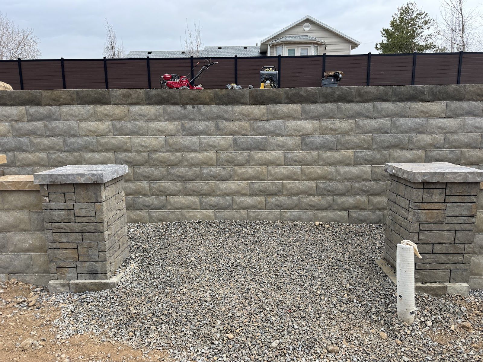 Capped block retaining wall with block pillars
