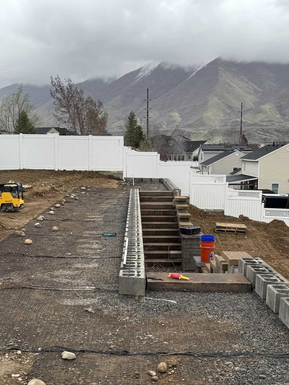 Block steps rising between retaining wall tiers